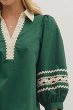 Hunter green Solid 3/4 puff sleeve top featuring contrast collar and scallop trim V-neck with rickrack trim on sleeve panels. Unlined. Woven. Non-sheer. Lightweight.