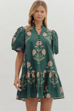 Hunter green Floral short bubble sleeve ruffle hem mini dress featuring ruffle neck band collar gold accent button closure. Side pockets. Lined. Woven. Non-sheer. Lightweight.