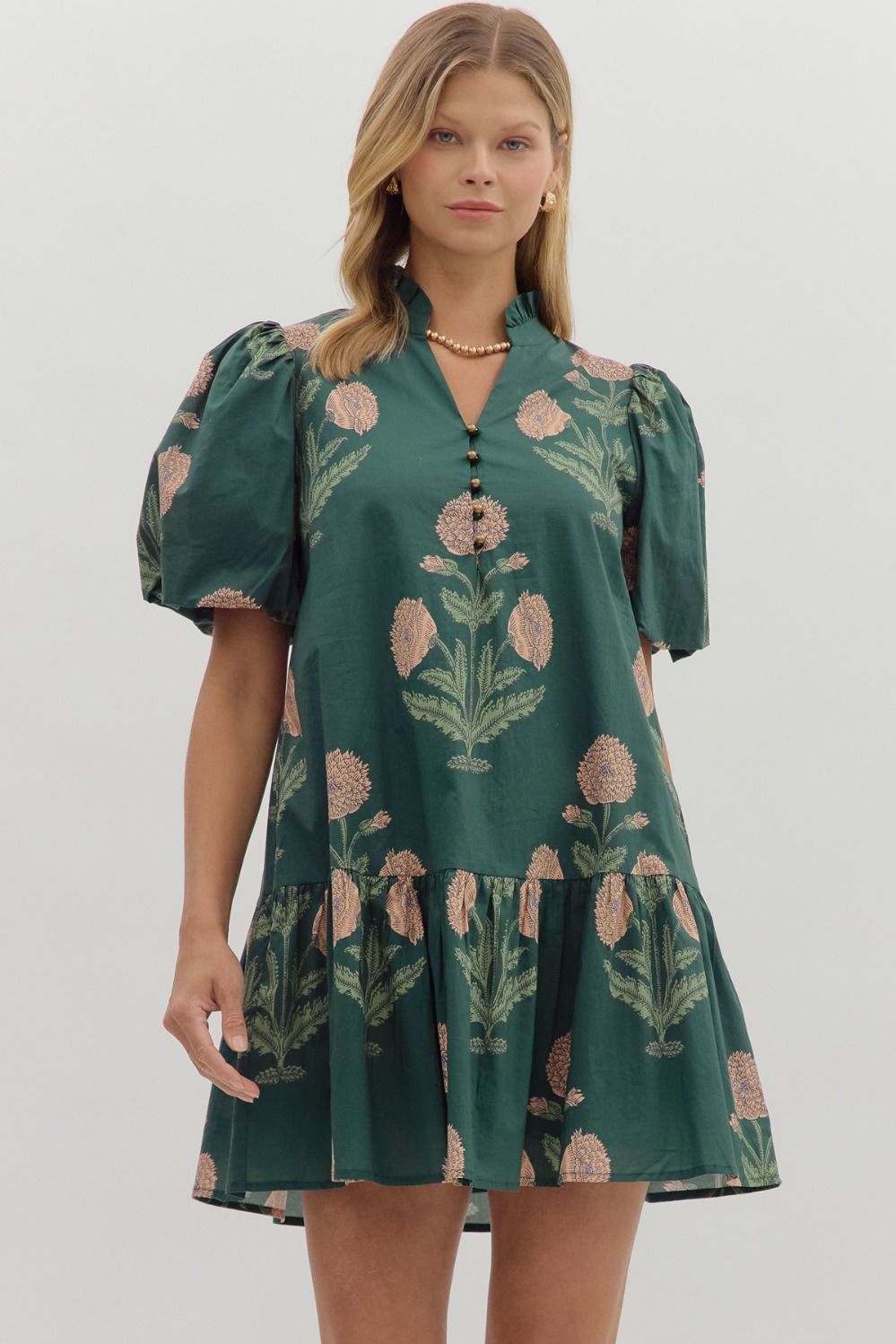 Hunter green Floral short bubble sleeve ruffle hem mini dress featuring ruffle neck band collar gold accent button closure. Side pockets. Lined. Woven. Non-sheer. Lightweight.