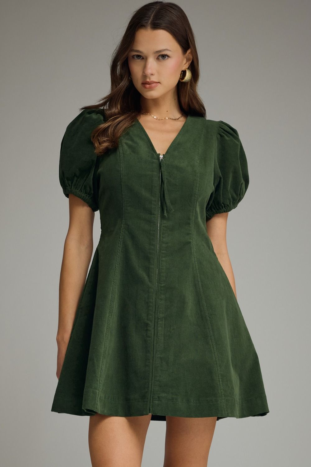 Hunter green Solid V-neck short puff sleeve dress featuring front zipper closure. Elasticated sleeve openings. Side pockets. Unlined. Woven. Non-sheer. Lightweight.