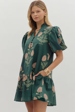 Hunter green Floral short bubble sleeve ruffle hem mini dress featuring ruffle neck band collar gold accent button closure. Side pockets. Lined. Woven. Non-sheer. Lightweight.