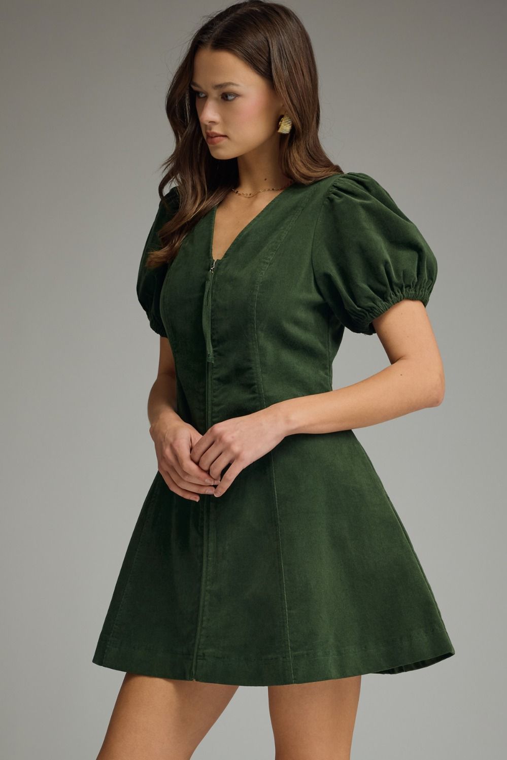 Hunter green Solid V-neck short puff sleeve dress featuring front zipper closure. Elasticated sleeve openings. Side pockets. Unlined. Woven. Non-sheer. Lightweight.