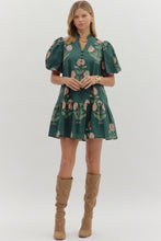 Hunter green Floral short bubble sleeve ruffle hem mini dress featuring ruffle neck band collar gold accent button closure. Side pockets. Lined. Woven. Non-sheer. Lightweight.