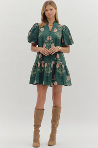 Hunter green Floral short bubble sleeve ruffle hem mini dress featuring ruffle neck band collar gold accent button closure. Side pockets. Lined. Woven. Non-sheer. Lightweight.