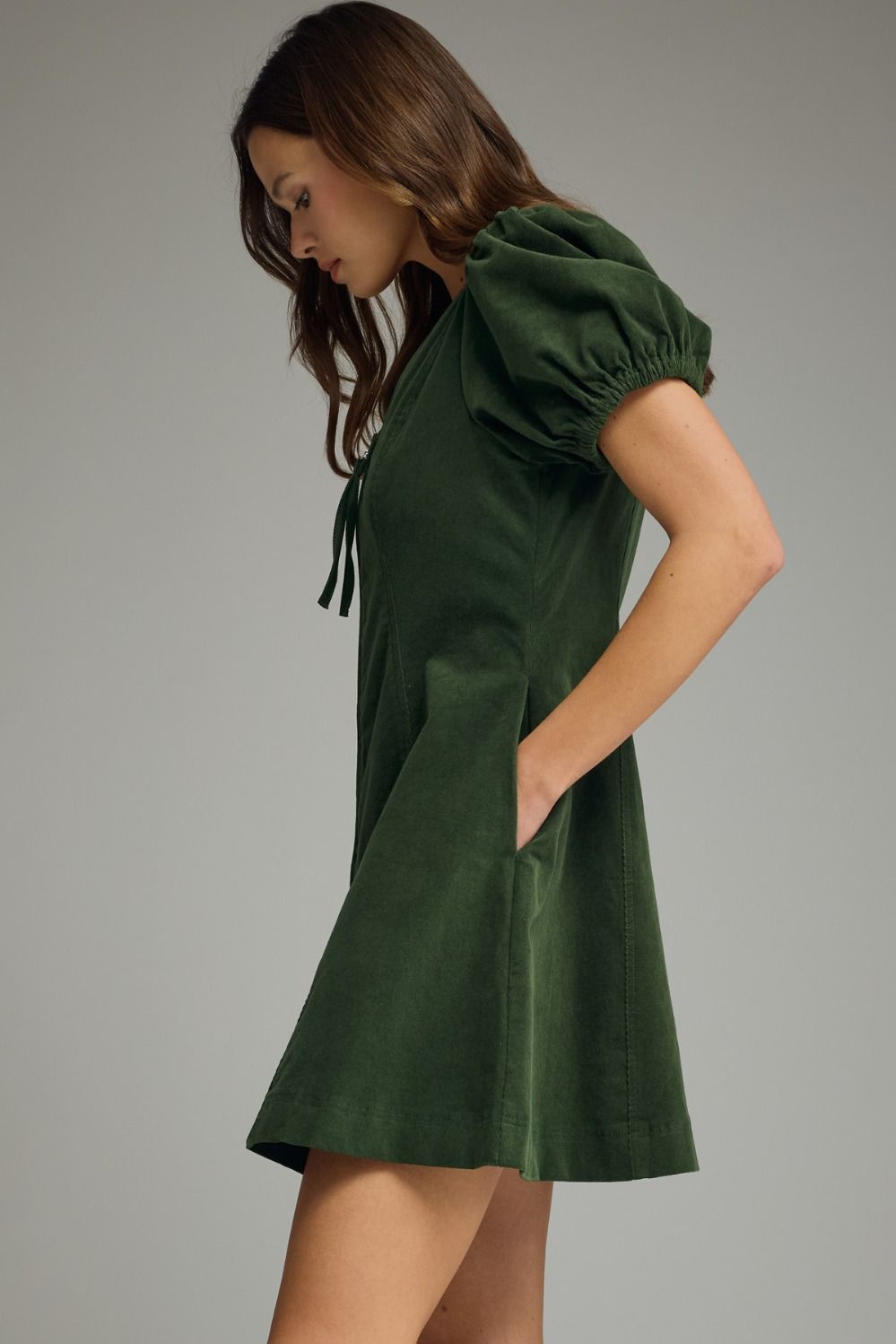 Hunter green Solid V-neck short puff sleeve dress featuring front zipper closure. Elasticated sleeve openings. Side pockets. Unlined. Woven. Non-sheer. Lightweight.
