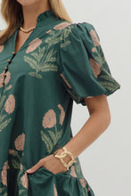 Hunter green Floral short bubble sleeve ruffle hem mini dress featuring ruffle neck band collar gold accent button closure. Side pockets. Lined. Woven. Non-sheer. Lightweight.