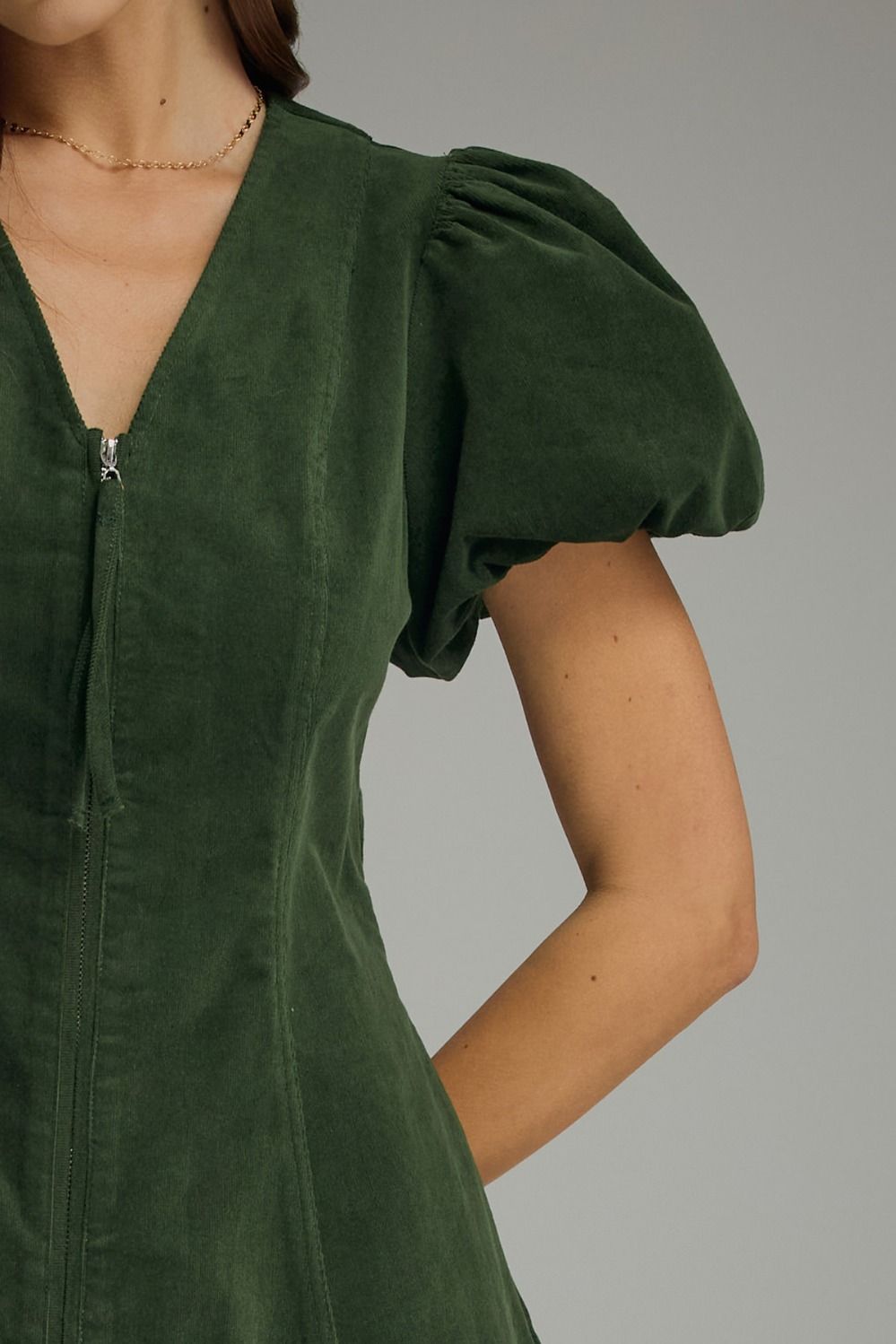 Hunter green Solid V-neck short puff sleeve dress featuring front zipper closure. Elasticated sleeve openings. Side pockets. Unlined. Woven. Non-sheer. Lightweight.